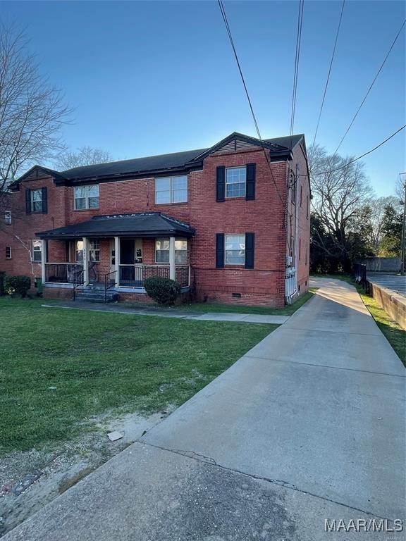 view of front of house with a porch and a front yard