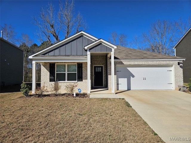 view of front of property with a front yard and a garage