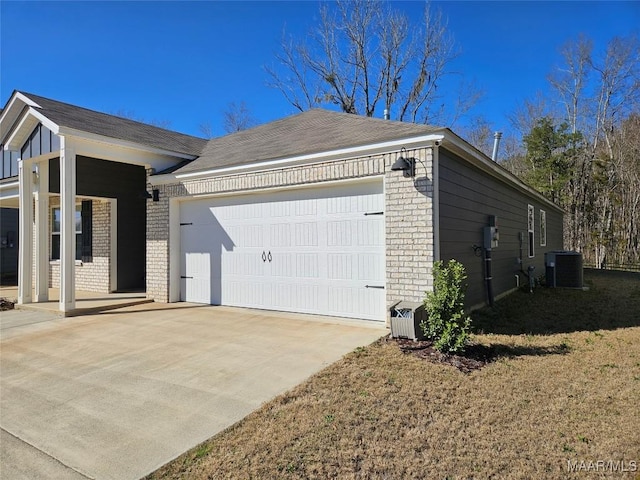 view of front of home featuring cooling unit and a garage