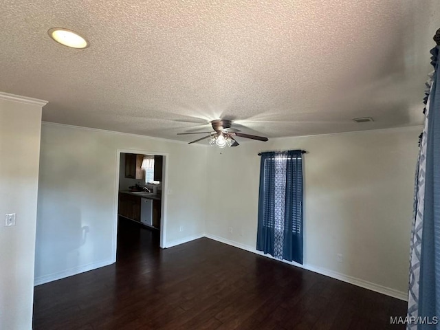 empty room featuring sink, dark wood-type flooring, a textured ceiling, and ceiling fan