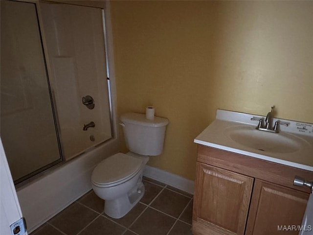 full bathroom featuring combined bath / shower with glass door, vanity, toilet, and tile patterned floors