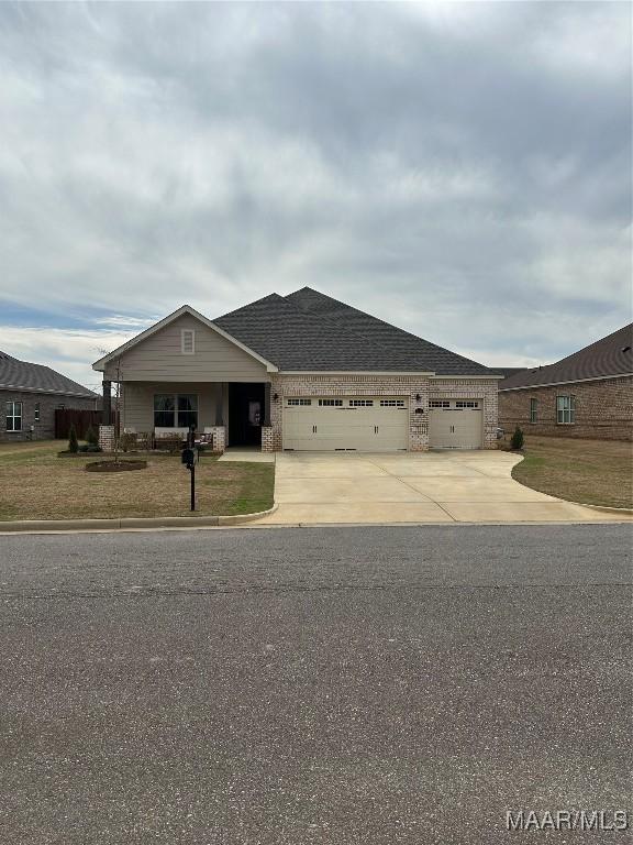 view of front of house with an attached garage, brick siding, concrete driveway, and roof with shingles