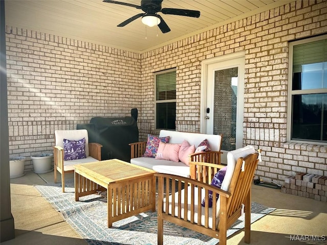 view of patio with ceiling fan and an outdoor living space