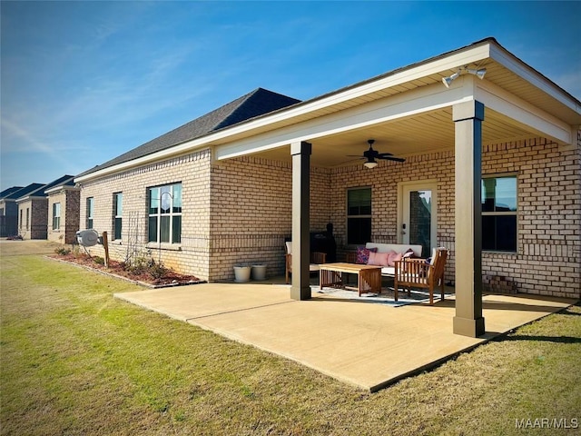 back of house featuring ceiling fan, a patio, brick siding, and outdoor lounge area