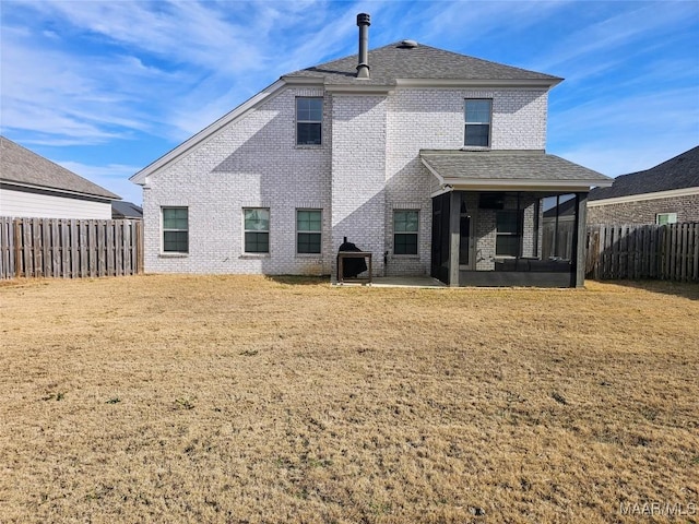 back of property featuring a sunroom, a lawn, and a patio area