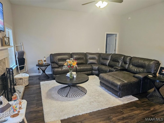 living room featuring ceiling fan and dark hardwood / wood-style flooring