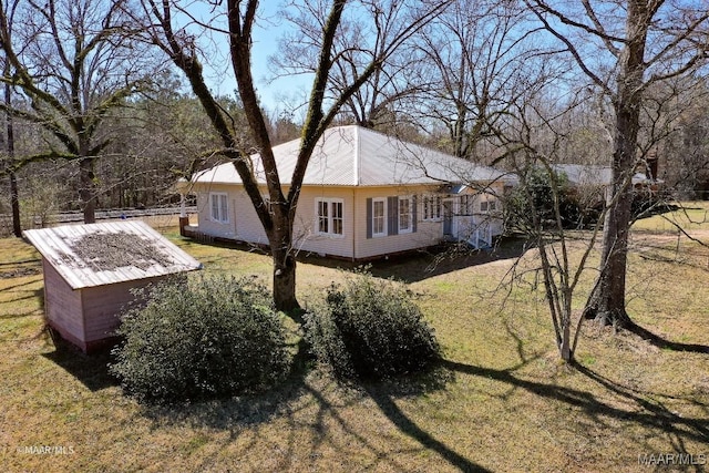 view of side of home featuring a yard