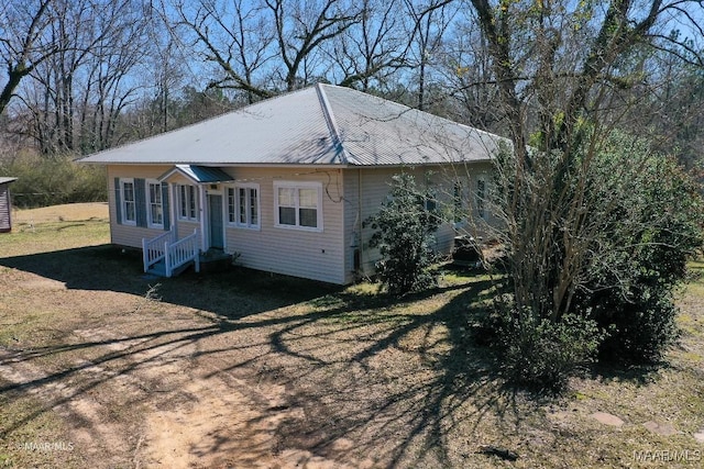 view of side of home with a yard