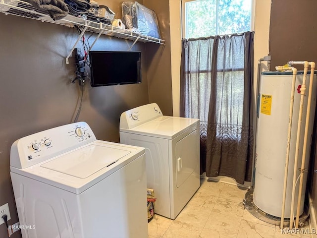 washroom with washer and dryer and water heater