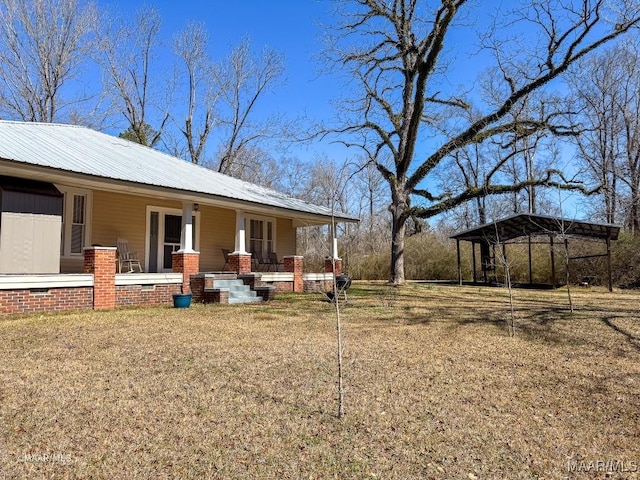 view of yard featuring covered porch and a carport