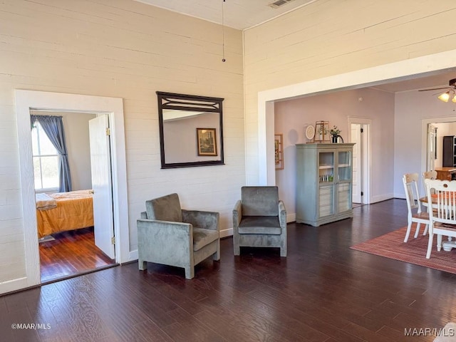 sitting room with dark hardwood / wood-style flooring and ceiling fan