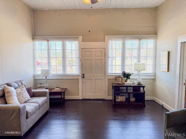 living room featuring dark hardwood / wood-style flooring, plenty of natural light, and wooden ceiling