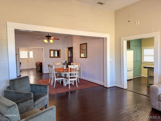 dining area featuring ceiling fan and dark hardwood / wood-style floors