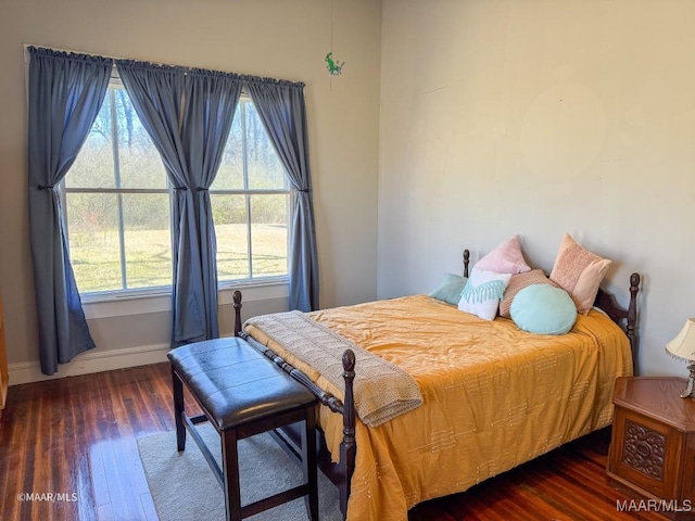 bedroom with dark hardwood / wood-style flooring