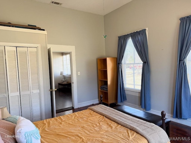 bedroom with a closet and dark hardwood / wood-style flooring