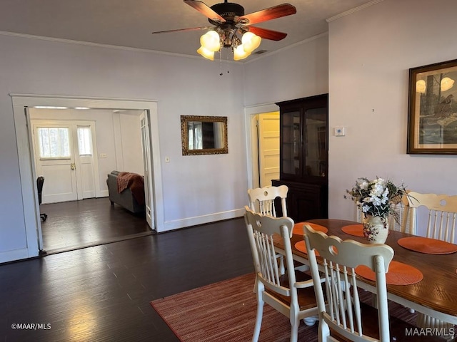 dining area with ceiling fan, crown molding, and dark hardwood / wood-style floors