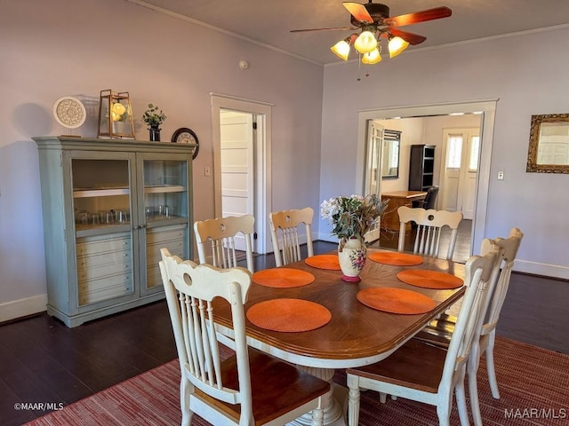 dining area with dark hardwood / wood-style flooring, ornamental molding, and ceiling fan