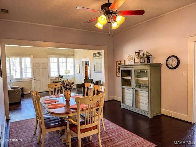 dining room featuring ceiling fan, ornamental molding, and dark hardwood / wood-style floors