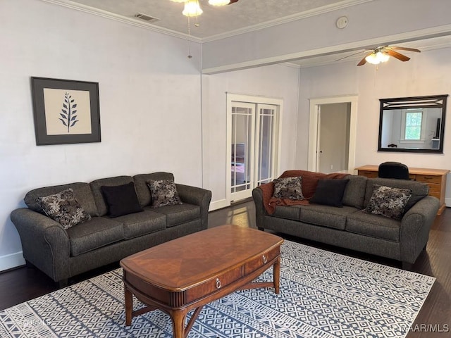 living room with ornamental molding, dark hardwood / wood-style flooring, and ceiling fan