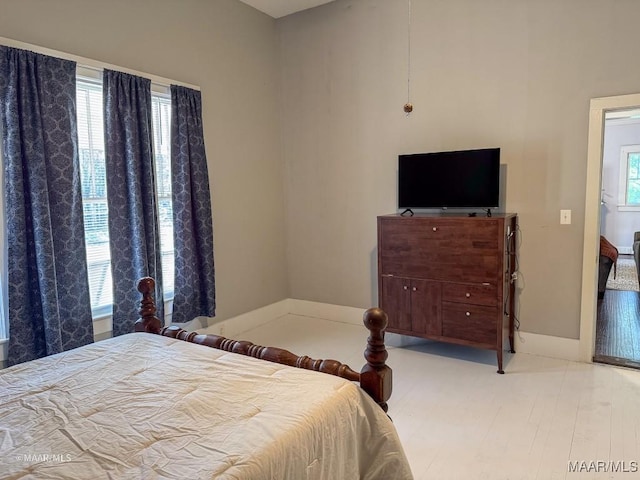 bedroom with multiple windows and light hardwood / wood-style floors