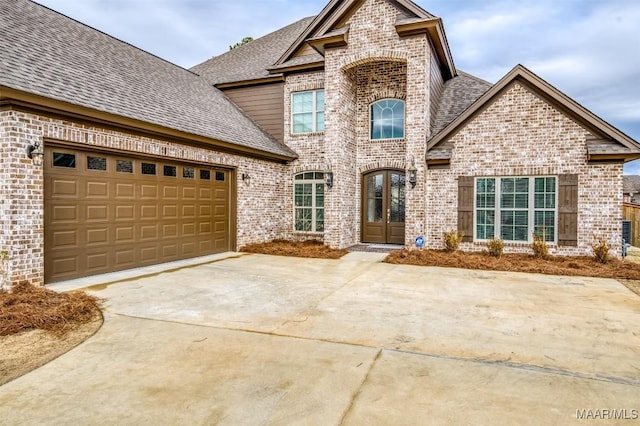 view of property with french doors and a garage