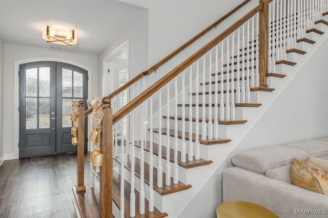 foyer with french doors and dark hardwood / wood-style flooring