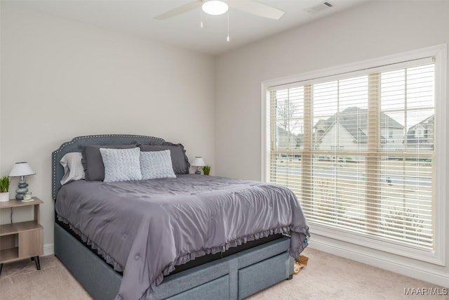 bedroom with ceiling fan and light carpet