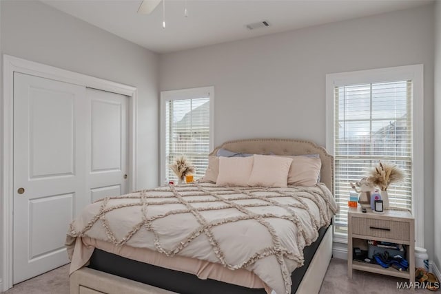 carpeted bedroom with a closet and ceiling fan