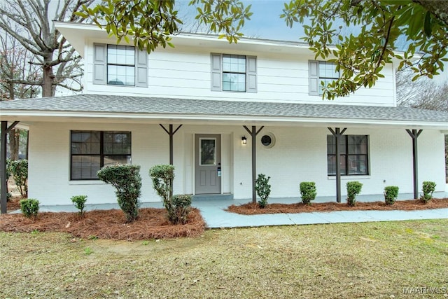 view of front facade featuring a front yard and a porch