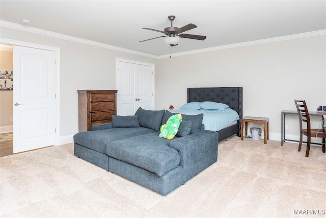 carpeted bedroom with a closet, ceiling fan, and ornamental molding