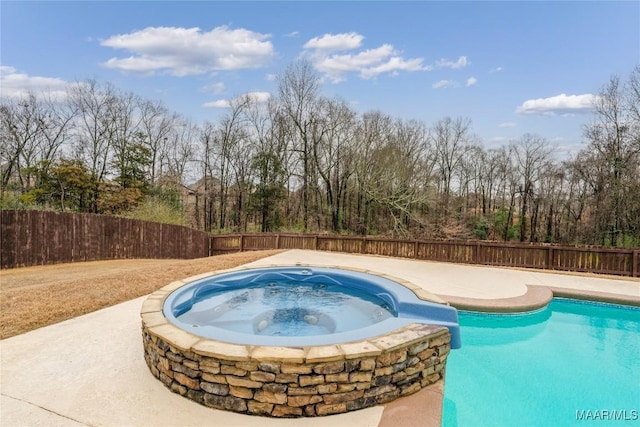 view of pool with an in ground hot tub