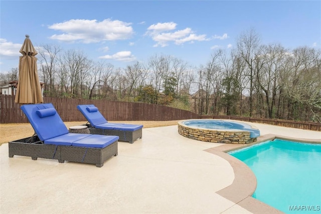 view of swimming pool with a patio and a hot tub