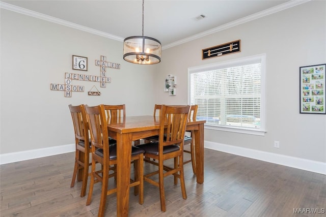 dining space with a chandelier, crown molding, and dark hardwood / wood-style floors