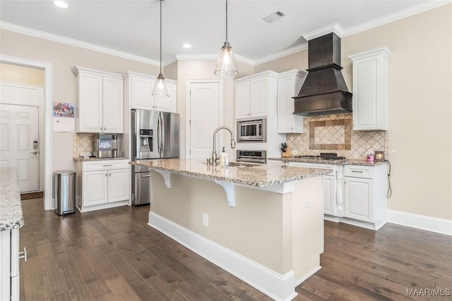 kitchen featuring appliances with stainless steel finishes, sink, custom range hood, and white cabinets