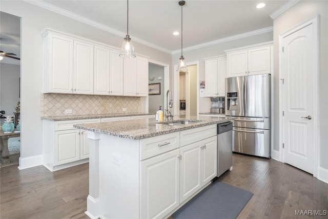 kitchen featuring an island with sink, white cabinetry, sink, light stone counters, and appliances with stainless steel finishes