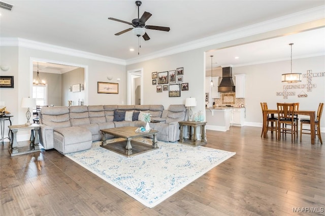 living room featuring ceiling fan, dark wood-type flooring, and ornamental molding