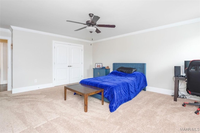 bedroom featuring carpet, a closet, ceiling fan, and ornamental molding