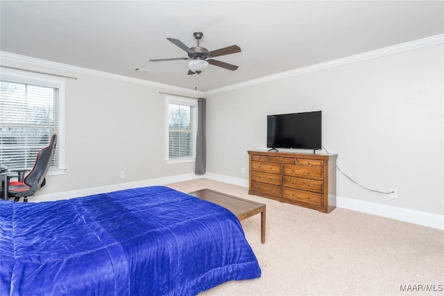 carpeted bedroom with ornamental molding and ceiling fan