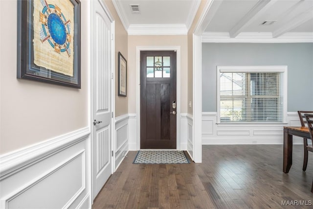 foyer entrance featuring dark wood-type flooring, beamed ceiling, and ornamental molding