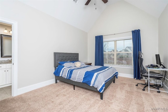 bedroom featuring light carpet, high vaulted ceiling, ensuite bathroom, and ceiling fan