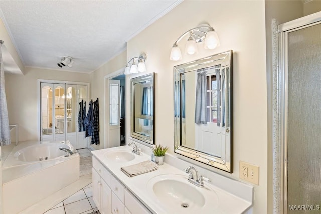 bathroom with vanity, independent shower and bath, a textured ceiling, and tile patterned floors