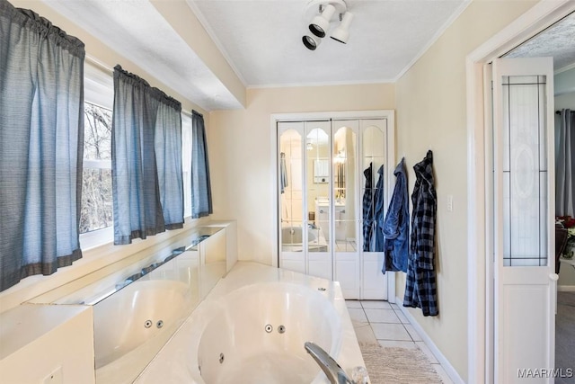 bathroom featuring tile patterned flooring, crown molding, and a tub