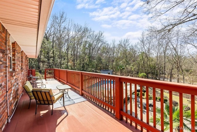 wooden balcony with a deck and a patio area