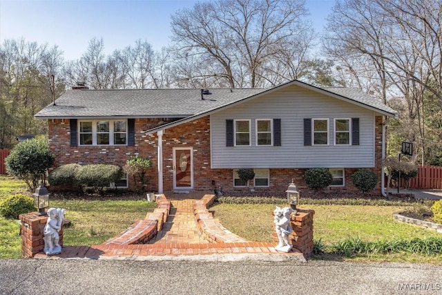 raised ranch featuring a front yard