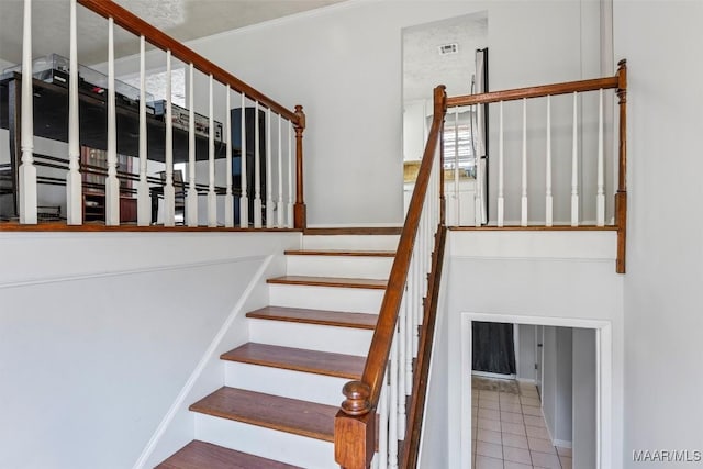 stairway featuring tile patterned floors