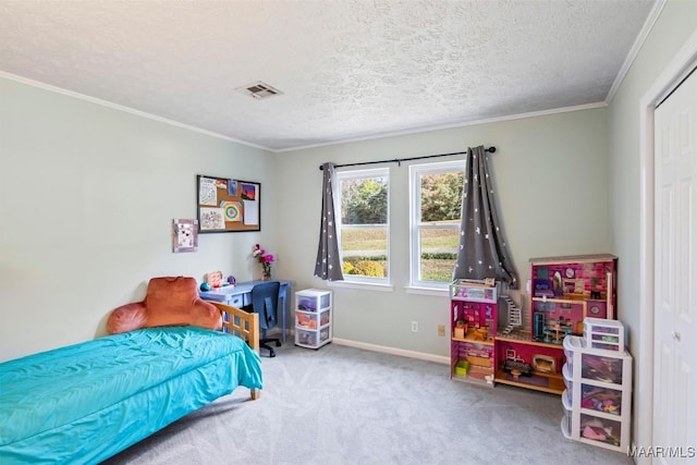 bedroom with a textured ceiling, ornamental molding, and carpet flooring