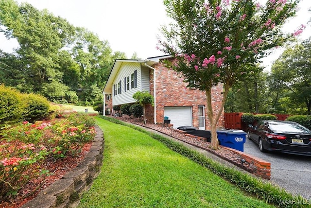 view of home's exterior featuring a garage and a yard