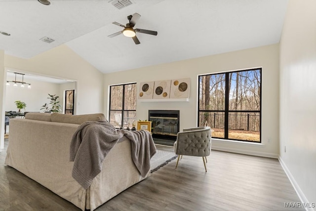 living room with hardwood / wood-style flooring, ceiling fan, and lofted ceiling