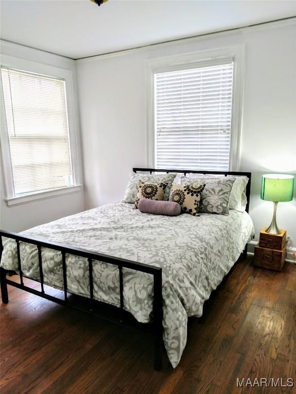 bedroom with dark wood-type flooring