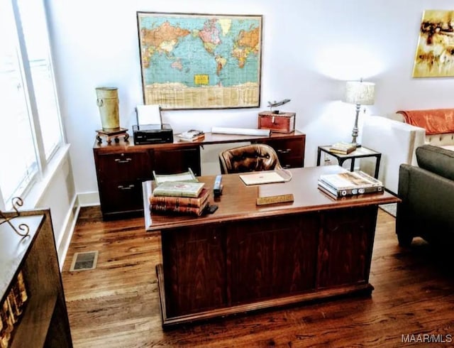 home office with dark hardwood / wood-style flooring